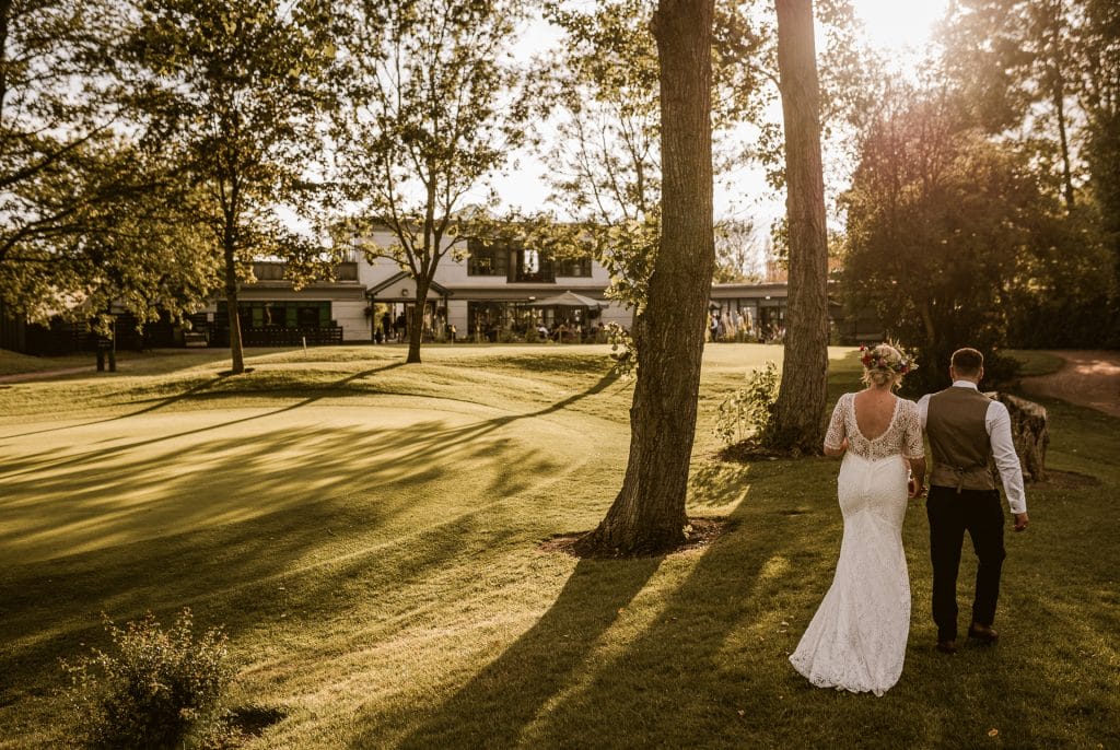 Married couple walking on the grounds of a wedding venue in Milton Keynes.